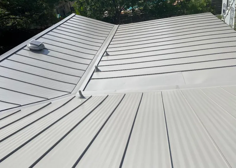 Solar attic fan installed on a metal roof for Roof Ventilation in Buenaventura Lakes